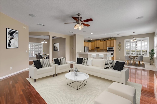 living room featuring hardwood / wood-style floors, a textured ceiling, and a healthy amount of sunlight