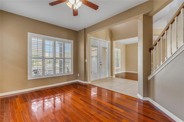 foyer entrance featuring ceiling fan and light wood-type flooring