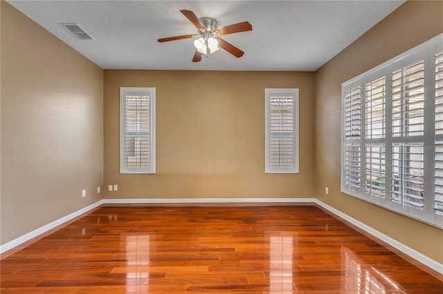 empty room featuring wood-type flooring and ceiling fan