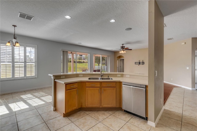 kitchen featuring light tile patterned flooring, stainless steel dishwasher, plenty of natural light, and sink