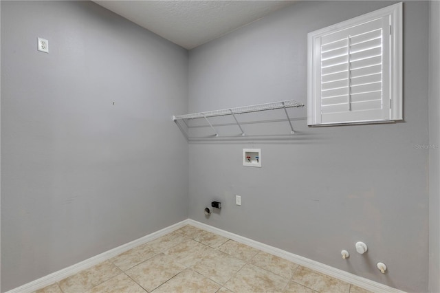 washroom featuring gas dryer hookup, washer hookup, and light tile patterned flooring