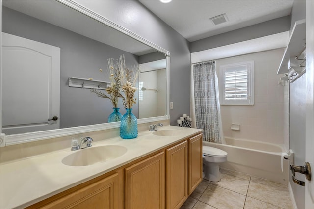 full bathroom featuring tile patterned flooring, toilet, vanity, and shower / bath combo with shower curtain