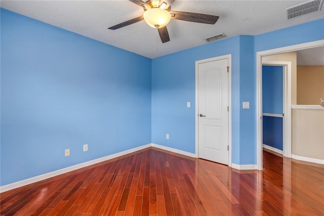 unfurnished bedroom featuring ceiling fan, hardwood / wood-style flooring, and a textured ceiling