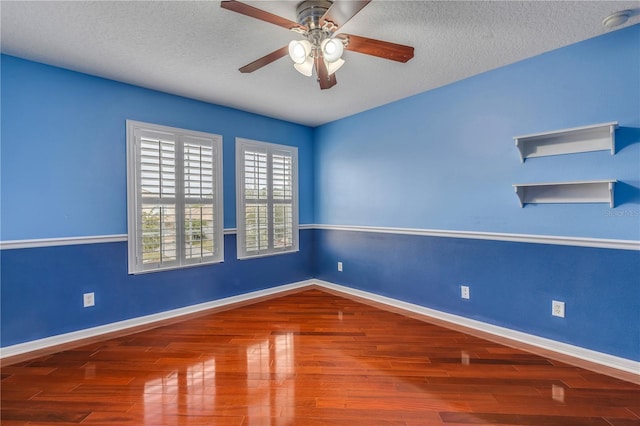 unfurnished room featuring ceiling fan, hardwood / wood-style flooring, and a textured ceiling