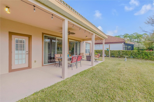 view of yard with a patio area and ceiling fan