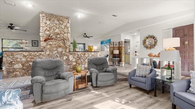 living room featuring vaulted ceiling, ceiling fan, and light hardwood / wood-style floors