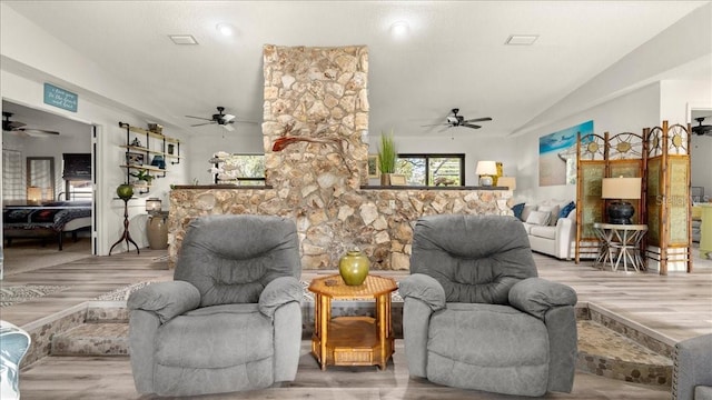 living room with lofted ceiling and light hardwood / wood-style flooring