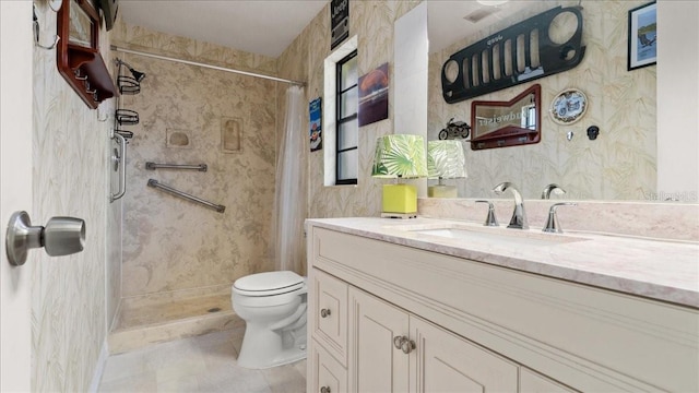 bathroom with vanity, tile patterned flooring, toilet, and walk in shower