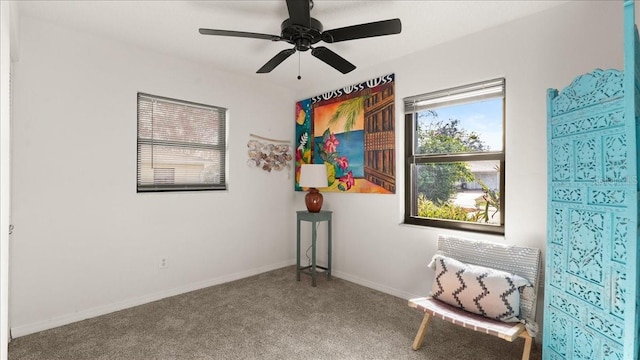 sitting room featuring ceiling fan and carpet flooring