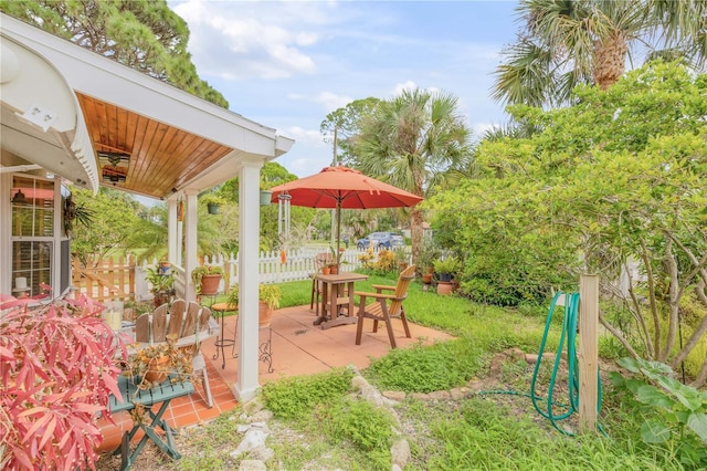 view of patio featuring fence