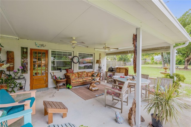 view of patio with outdoor dining area, fence, an outdoor living space, and ceiling fan