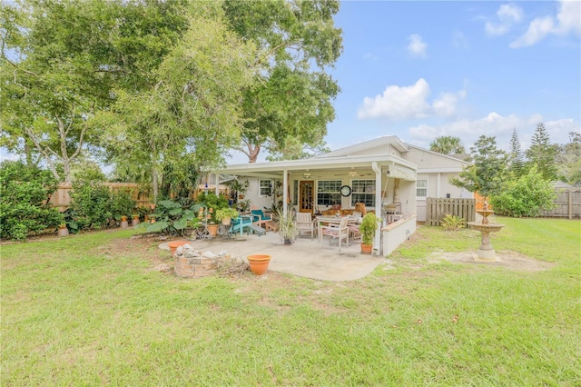 back of house featuring ceiling fan, a patio, a lawn, and fence