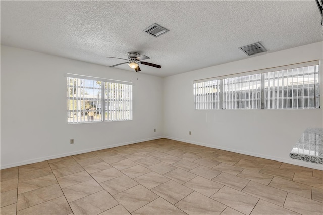 unfurnished room featuring a textured ceiling and ceiling fan