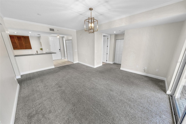 unfurnished living room featuring ornamental molding, light colored carpet, and a chandelier