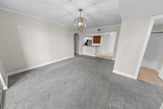 unfurnished living room featuring light carpet, crown molding, and a chandelier