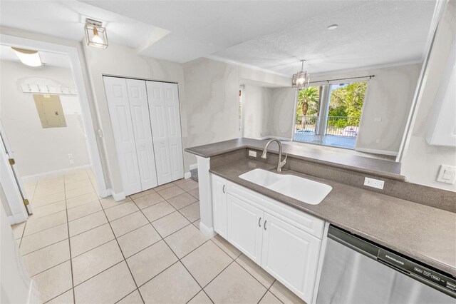 kitchen with dishwasher, sink, white cabinets, light tile patterned floors, and a textured ceiling