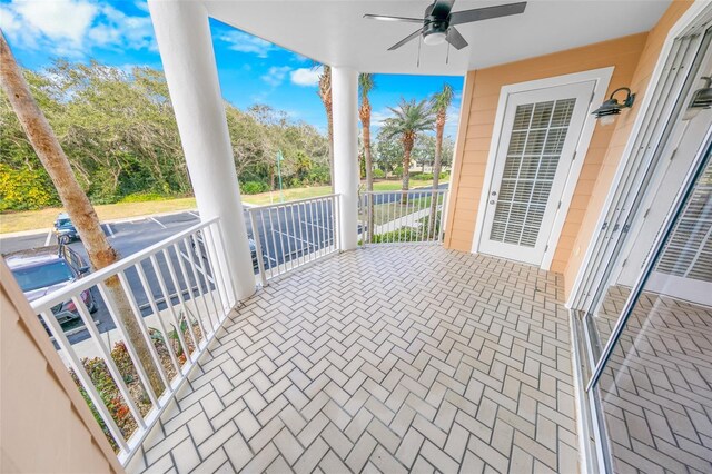 view of patio with ceiling fan and a porch