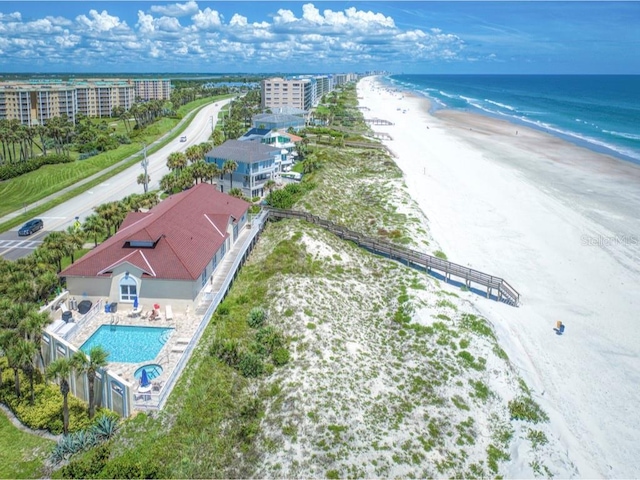 birds eye view of property with a beach view and a water view