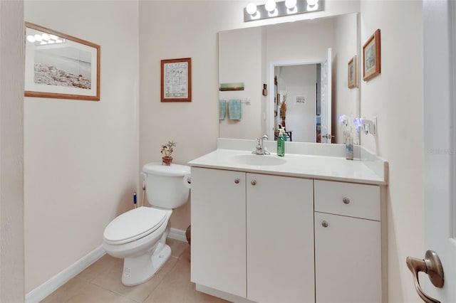 bathroom with tile patterned flooring, vanity, and toilet