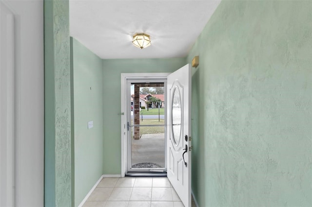 foyer with light tile patterned floors and baseboards