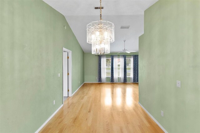 unfurnished dining area featuring lofted ceiling, light wood-style flooring, visible vents, and baseboards