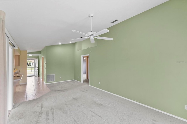 empty room featuring light colored carpet, visible vents, baseboards, and light tile patterned floors