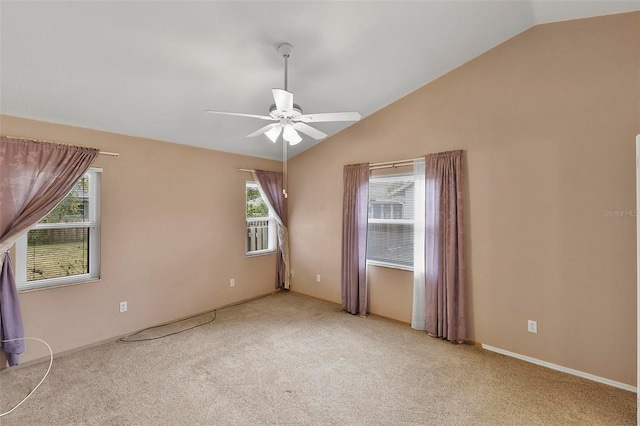 unfurnished room with vaulted ceiling, a ceiling fan, and light colored carpet