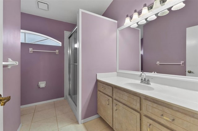 full bath with a stall shower, vanity, baseboards, and tile patterned floors