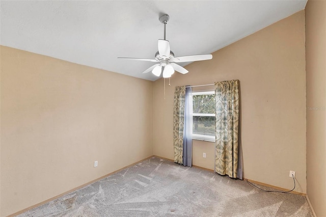 empty room featuring ceiling fan, carpet floors, and baseboards