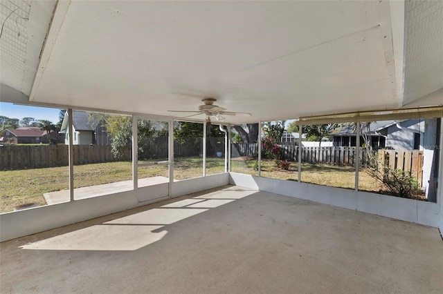 unfurnished sunroom with ceiling fan