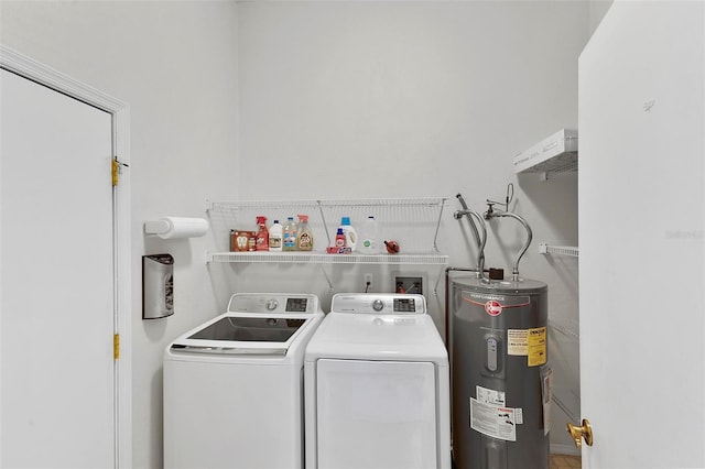 laundry area with washer and dryer, laundry area, and electric water heater