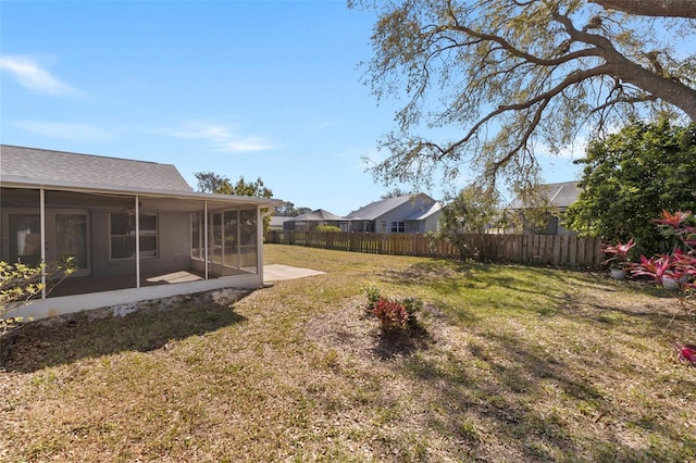 view of yard featuring a sunroom and fence