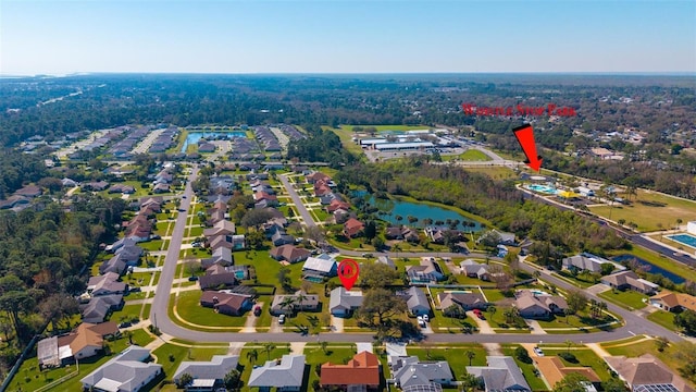 drone / aerial view with a water view and a residential view