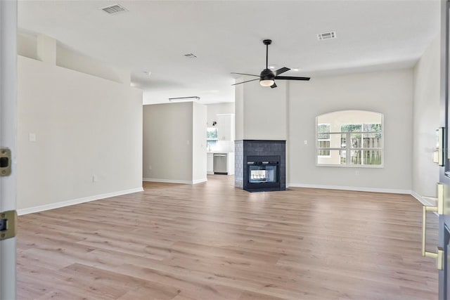 unfurnished living room with light wood-type flooring, vaulted ceiling, and ceiling fan