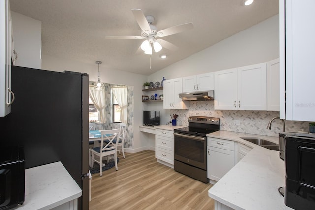 kitchen with lofted ceiling, sink, white cabinetry, backsplash, and stainless steel appliances