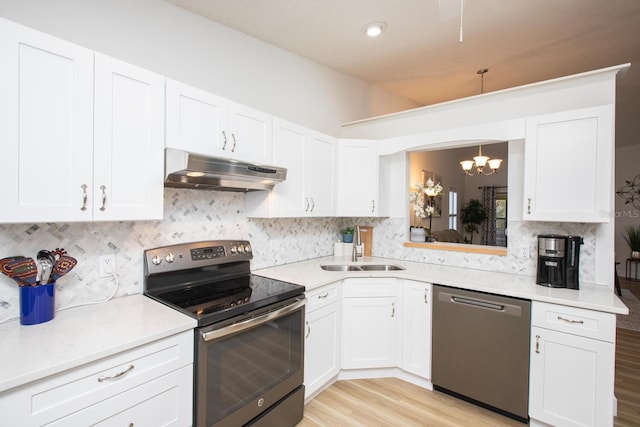 kitchen with stainless steel appliances, white cabinetry, sink, and light hardwood / wood-style flooring