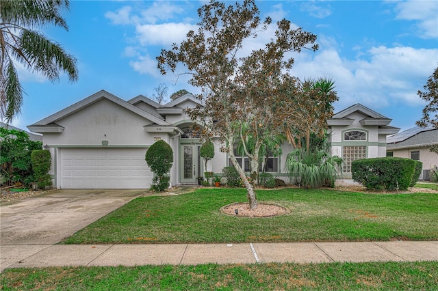 view of front of property with a garage and a front lawn