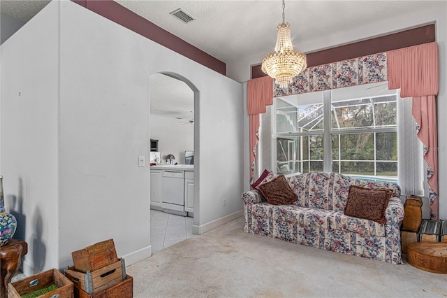 interior space featuring ceiling fan with notable chandelier and a textured ceiling