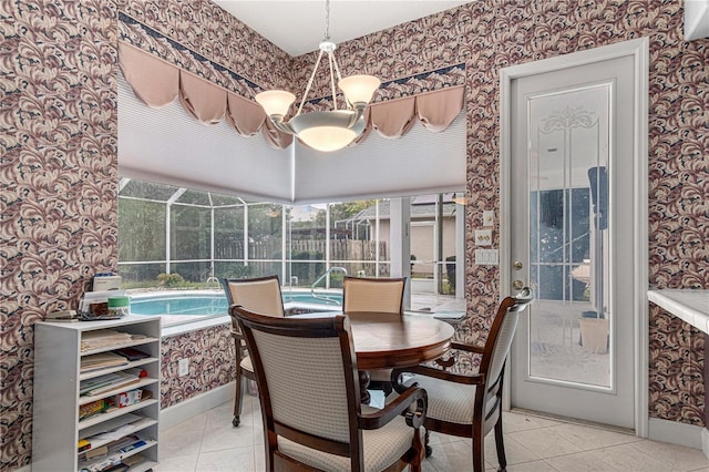 sunroom featuring a healthy amount of sunlight and a chandelier