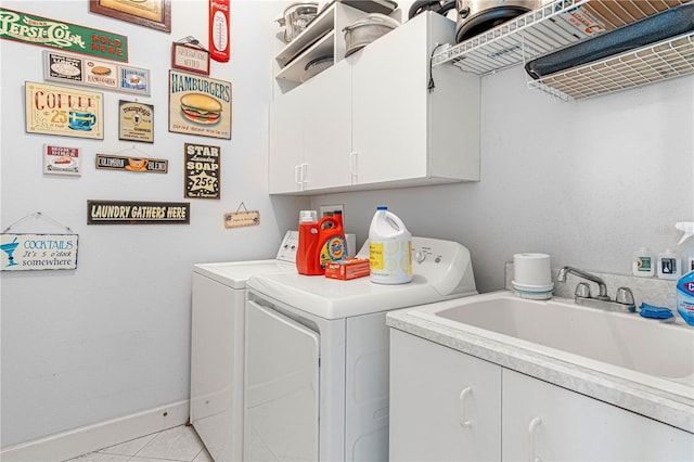 laundry room featuring cabinets, sink, washer and dryer, and light tile patterned floors