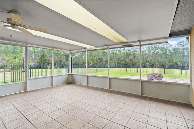 unfurnished sunroom with ceiling fan and plenty of natural light