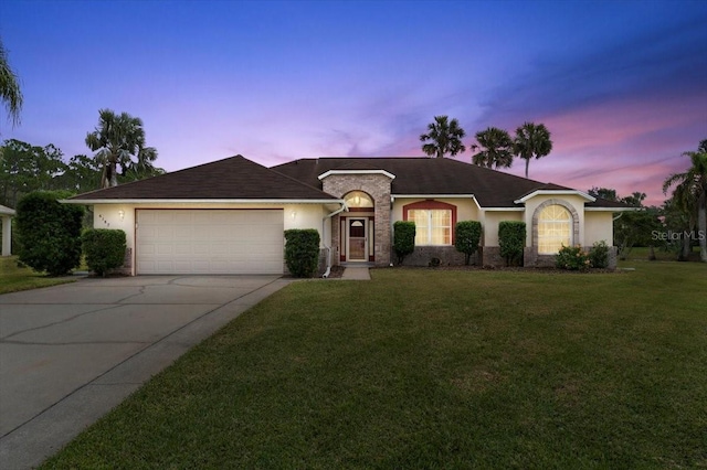 single story home with a yard and a garage