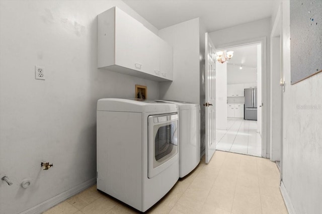 washroom with cabinets and washing machine and clothes dryer