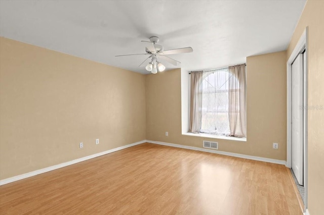 empty room with light hardwood / wood-style flooring and ceiling fan