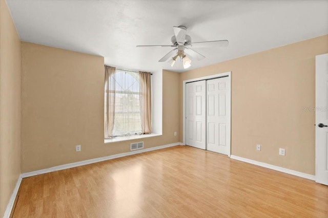 unfurnished bedroom featuring a closet, ceiling fan, and light hardwood / wood-style flooring