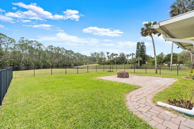 view of yard with an outdoor fire pit and a patio