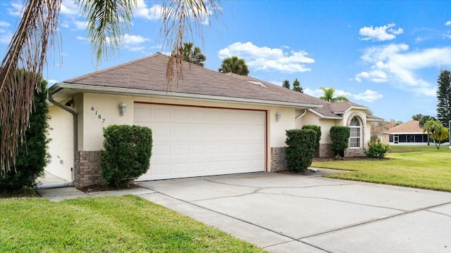 ranch-style home featuring a garage and a front lawn