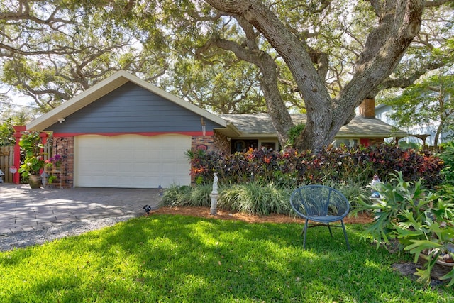 view of front of house featuring a garage and a front lawn