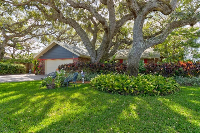 view of front of property featuring a garage and a front yard