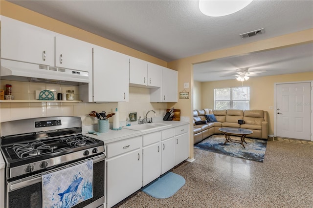 kitchen featuring sink, ceiling fan, stainless steel gas stove, a textured ceiling, and white cabinets